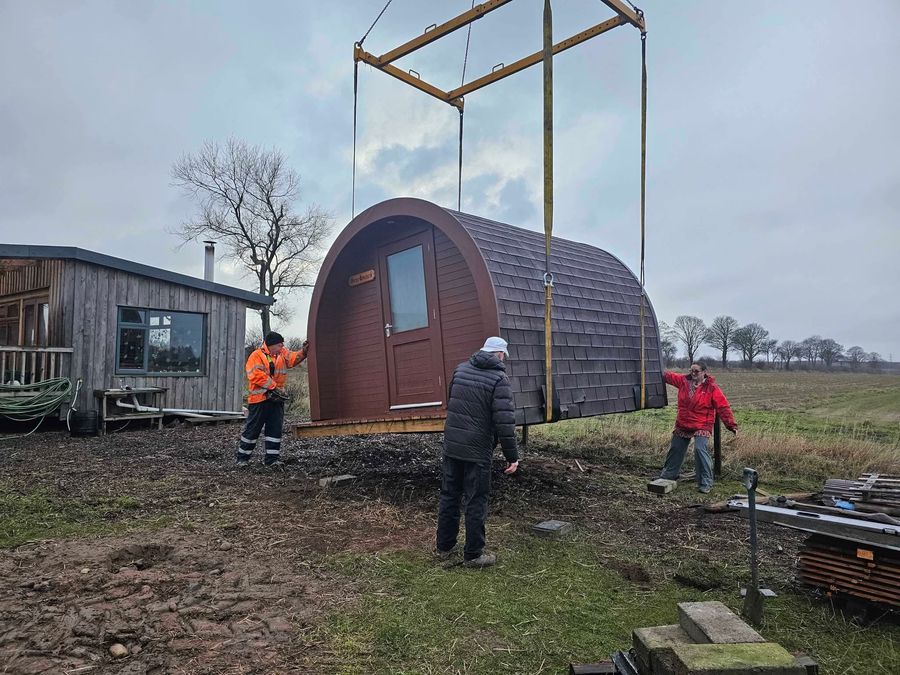 Lowering the new glamping pod into place by crane