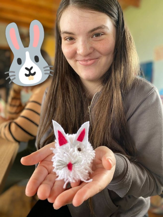 Showing off a handmade pom-pom bunny craft