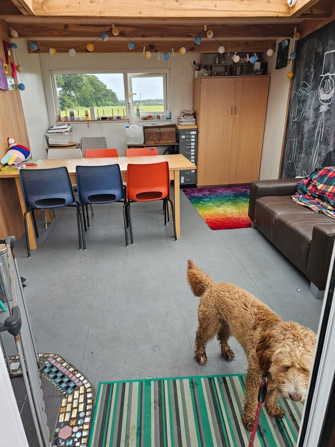 A peek into the art room, complete with a curious visitor at the door